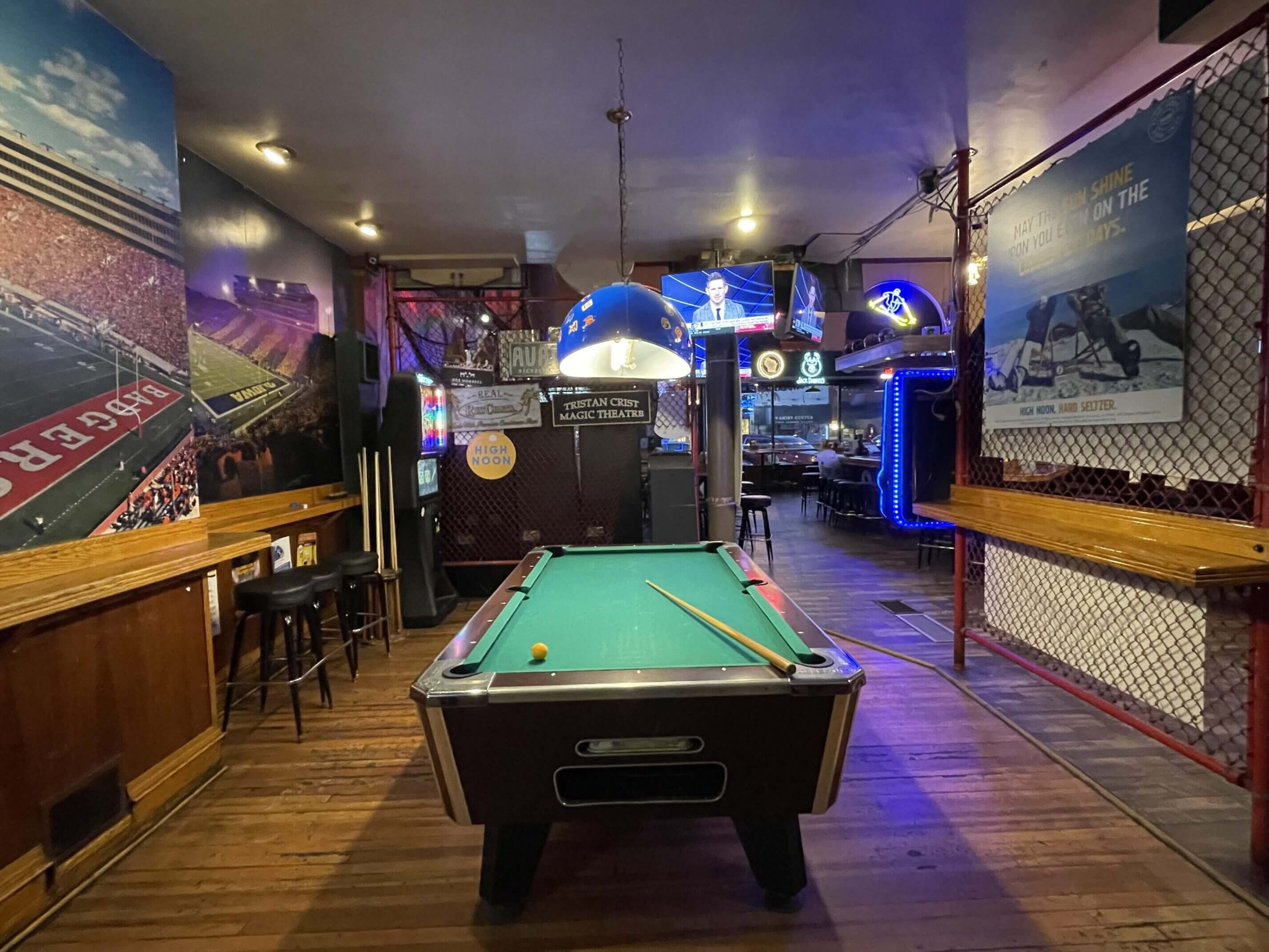 Pool table in a dimly lit bar.
