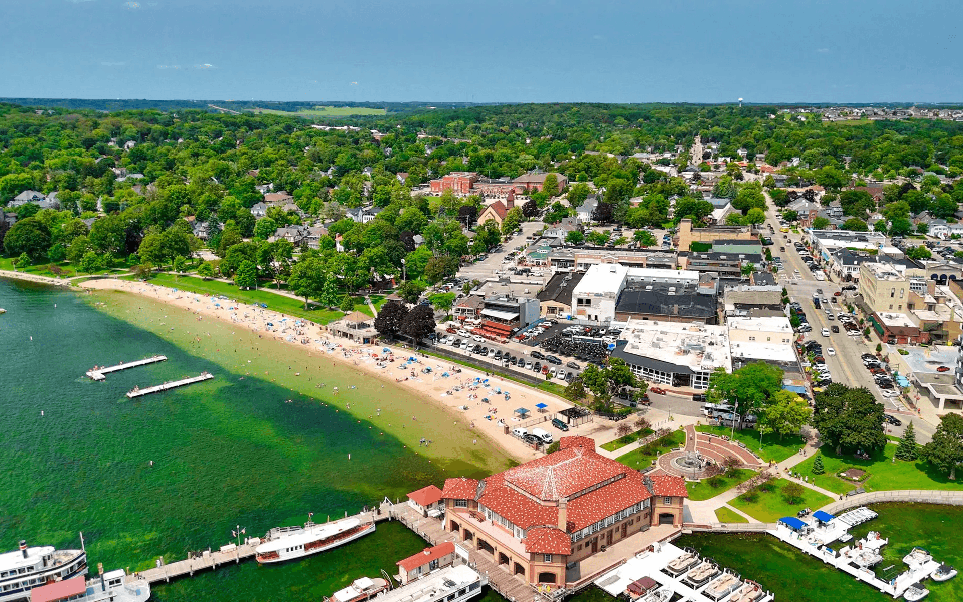Aerial view of a coastal town with a beach and marina.