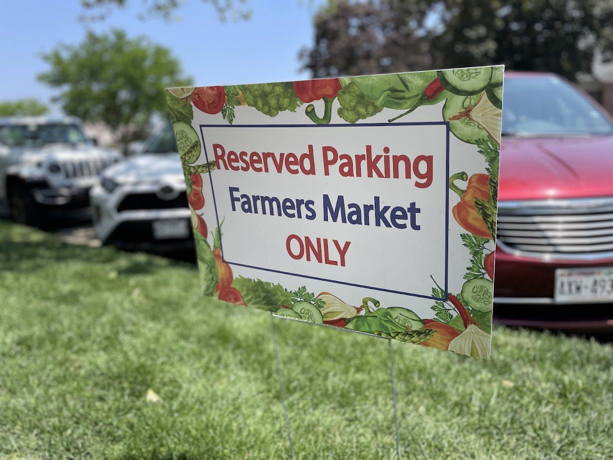 Reserved parking sign for Farmers Market only.