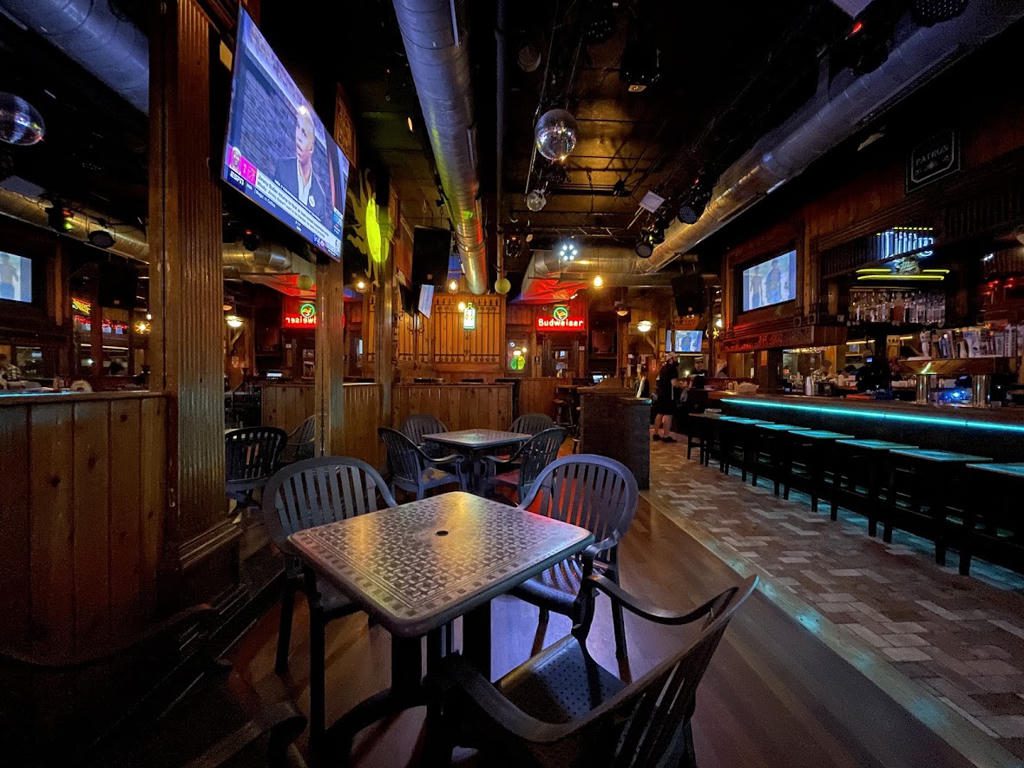 Cozy bar interior with wooden decor and seating.
