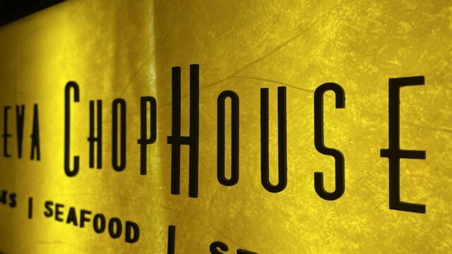 Golden textured wall with bold black 'ChopHouse' restaurant sign.