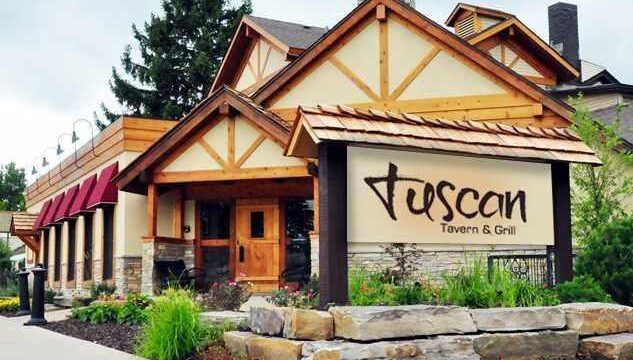 Entrance of Tuscan Tavern & Grill with rustic wooden architecture.