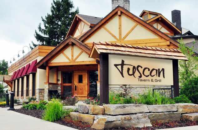 Entrance of Tuscan Tavern & Grill with rustic wooden architecture.