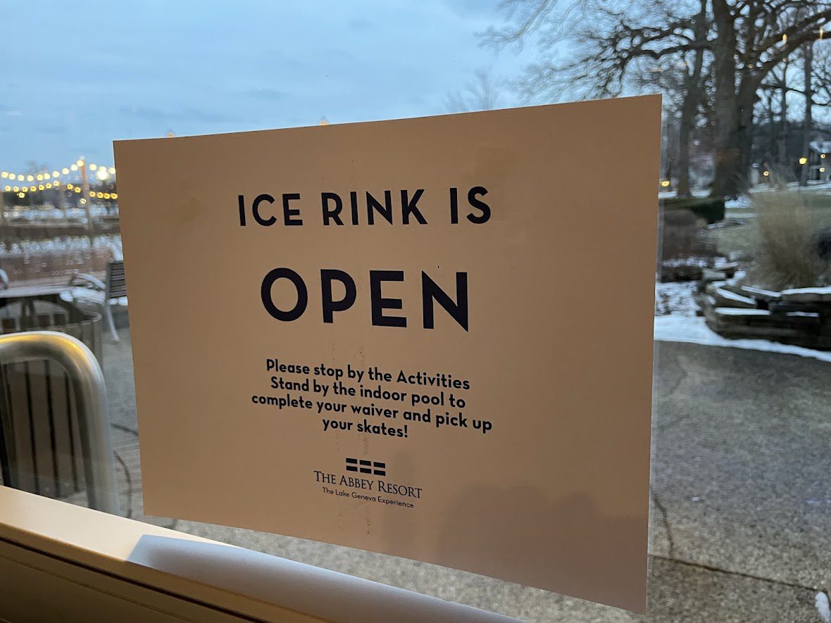 Sign announcing the ice rink is open with safety instructions.