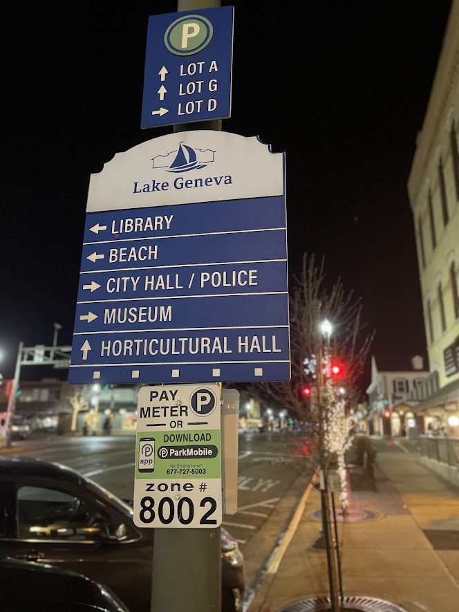 Night street view with directional signs in Lake Geneva.