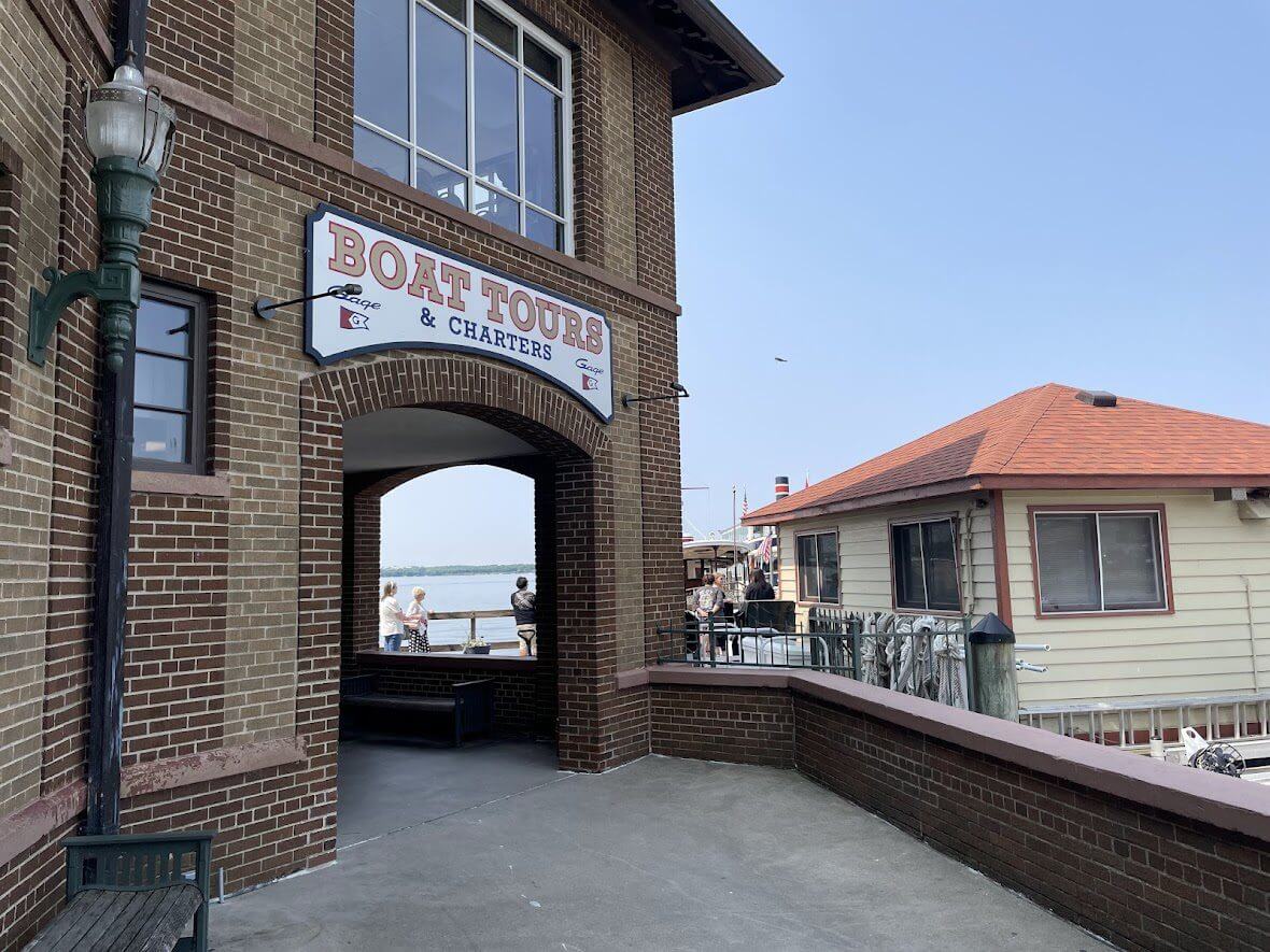 Entrance to Dog House, a cozy eatery with brick walls and a small patio.