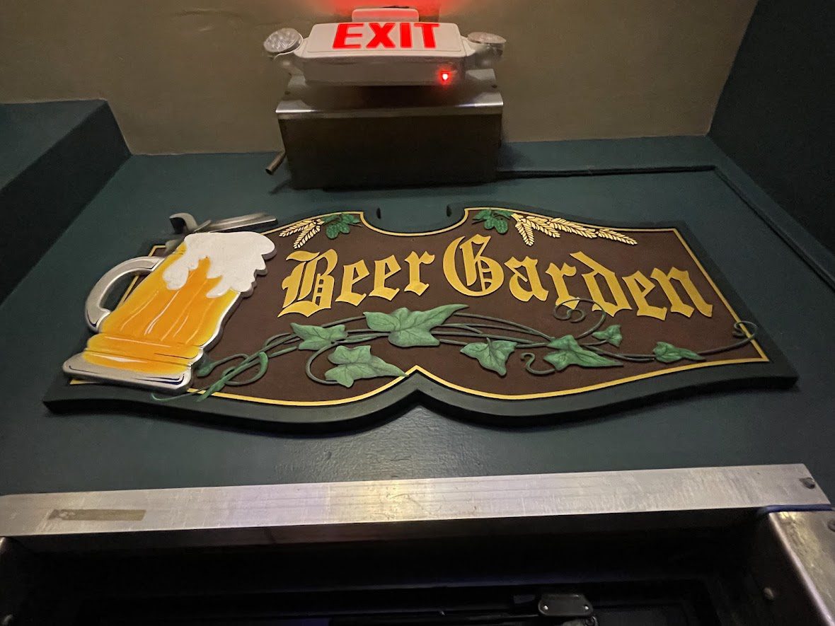 Vintage Beer Garden sign with beer mug graphic under an EXIT sign.