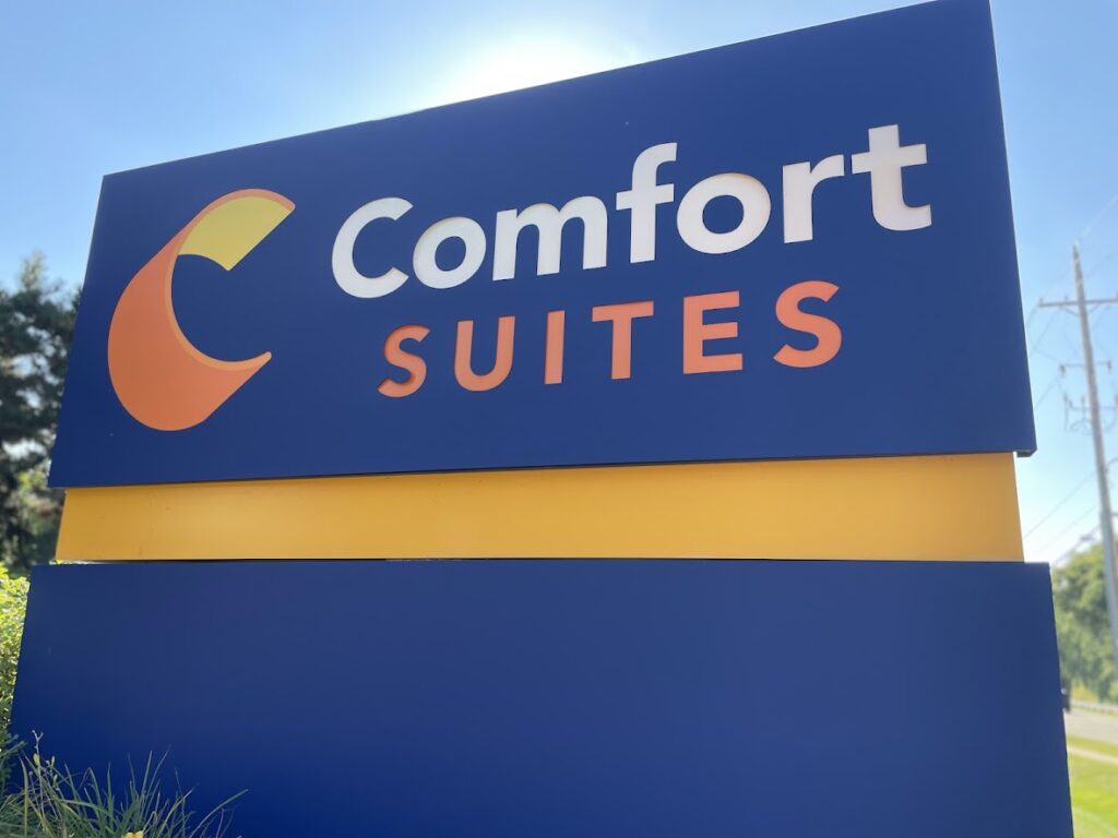 Comfort Suites hotel sign with blue and orange colors.