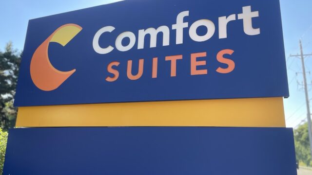 Comfort Suites hotel sign with blue and orange colors.
