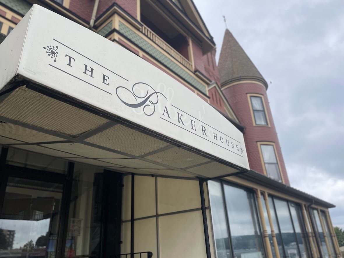Exterior view of The Baker's shop with brick architecture and turret.